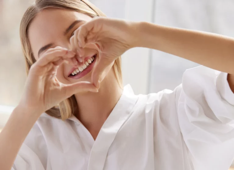 a girl making a heart sign