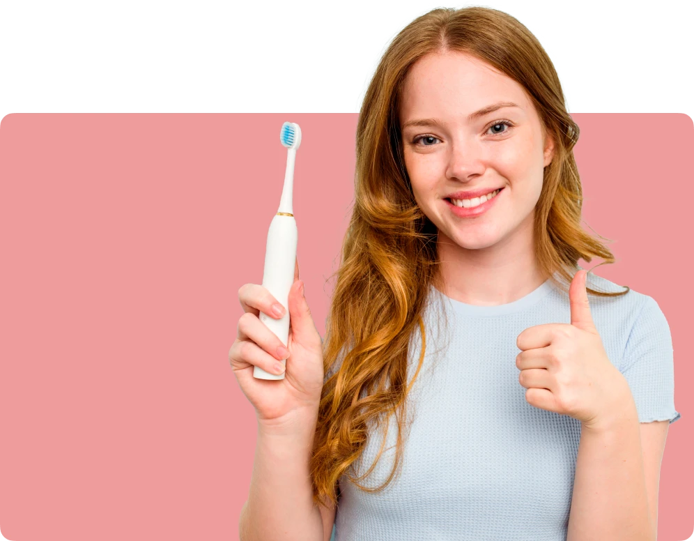 female smile holding a toothbrush