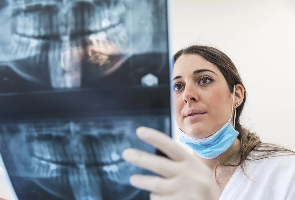 dentist looking x-ray picture