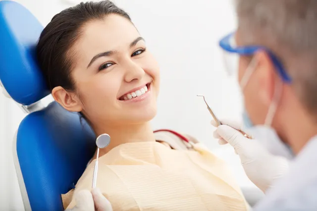 patient sitting in dental chair happy